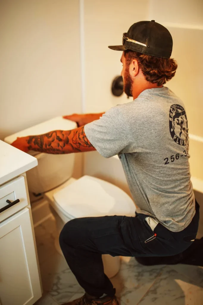 B&C Plumbing technician performing commercial plumbing toilet repair installation in Huntsville