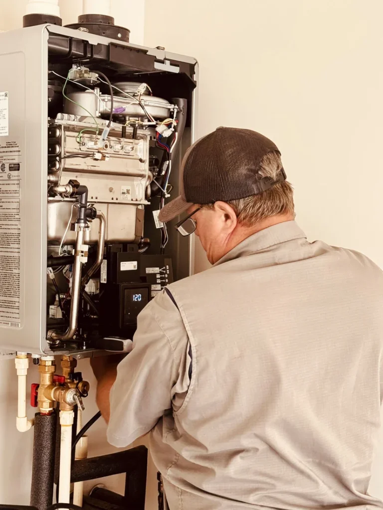 B&C Plumbing technician installing a commercial plumbing water heater in Huntsville